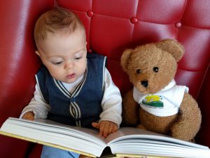 Henry reading to Oliver Bear